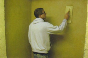 James plastering a wall